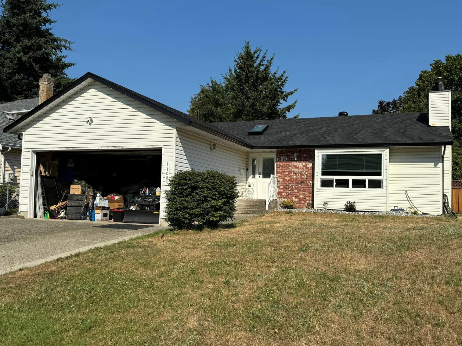 After: new black architectural shingle roof on the same Surrey rancher by Roofking