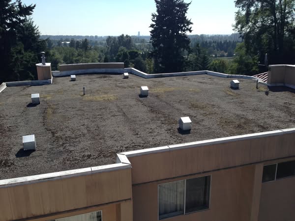 Before: tar and gravel flat roof on a Burnaby commercial building before torch-on conversion by Roofking